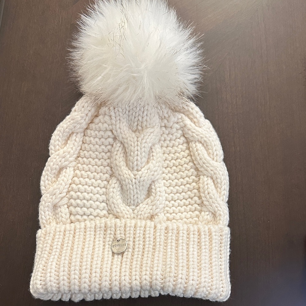 Express Fuzzy Pom Pom Beanie in a cream cable-knit